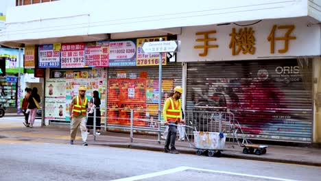 workers setting up barriers on a busy street