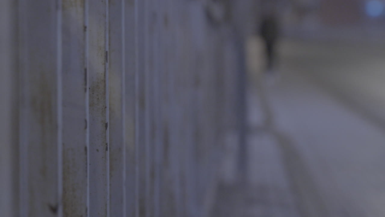 Indoor corridor at night with people walking