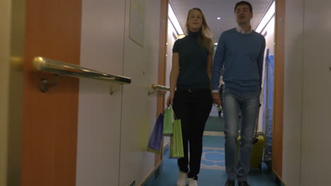 young couple moving into hotel room