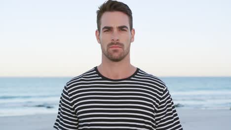 retrato de un joven de pie en una playa 4k