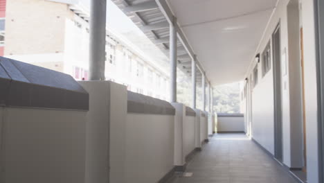 walking in school hallway, student with backpack heading to classroom