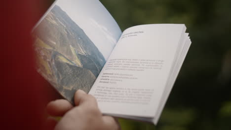 brochure and the hand of a hiker