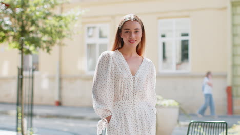 portrait of happy woman stands with her back turns around smiling glad expression looking at camera