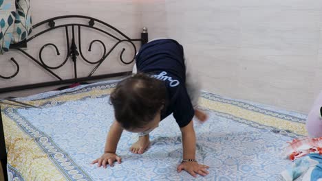 Un-Lindo-Niño-Pequeño-Tratando-De-Pararse-Por-Primera-Vez-En-La-Cama-En-Casa