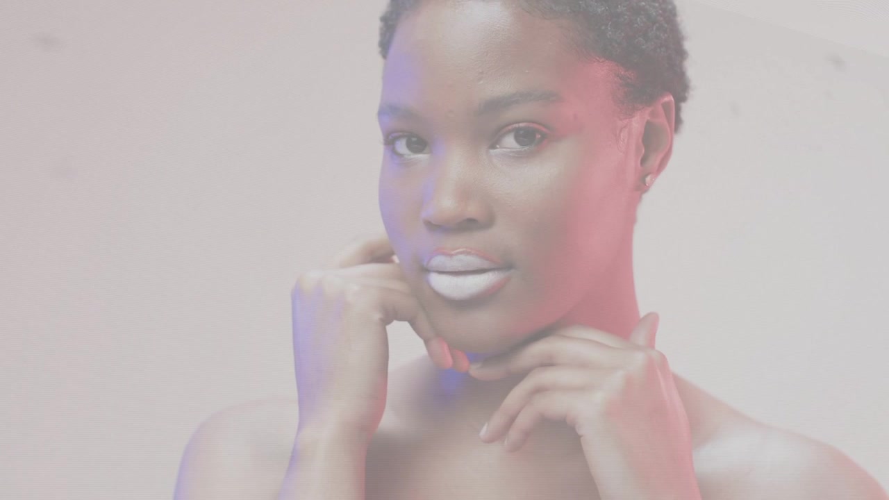 Female model opening eyes and lifting gaze for beauty shoot, soft rim lights showing white lipstick