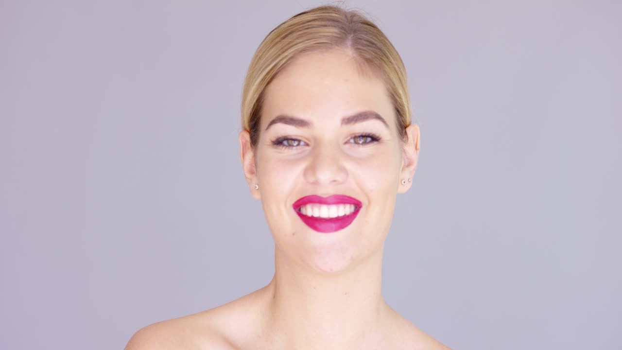 Laughing young woman wearing red lipstick