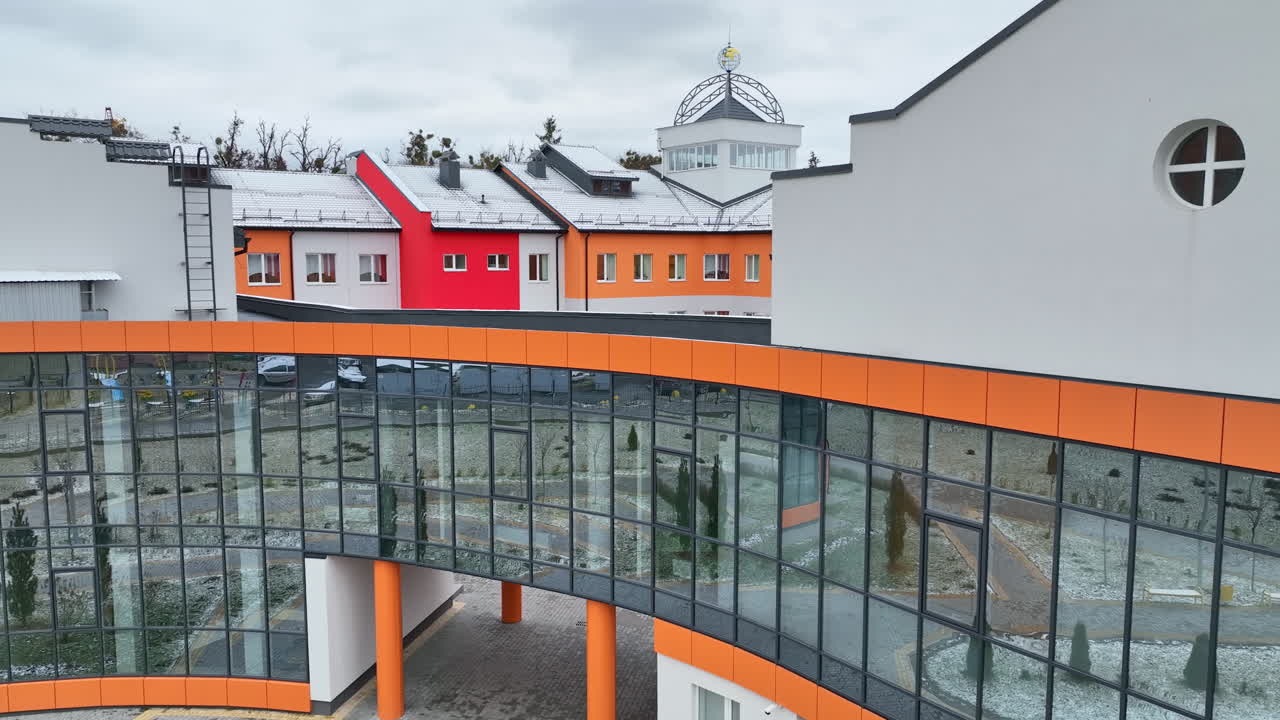 Beautiful new building with cupola atop. Colorful design of some parts of the building in mix with white walls.