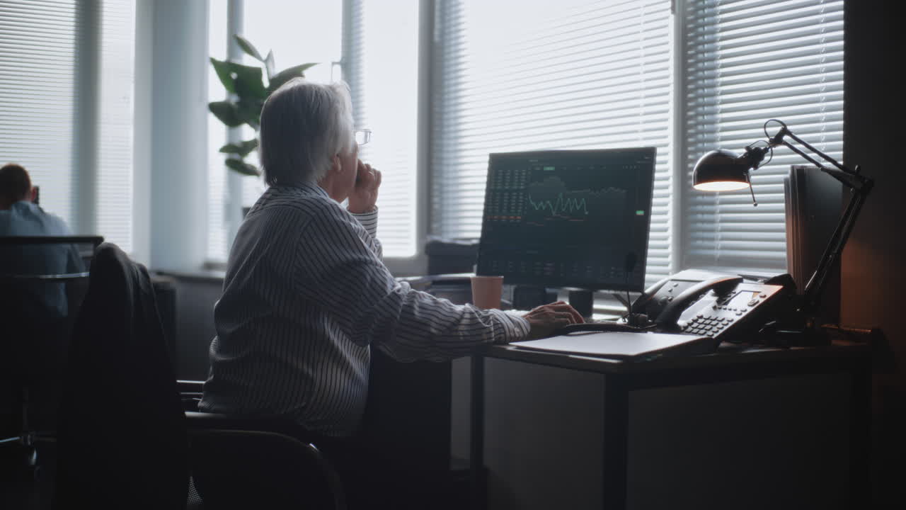 Senior Businessman Working on Financial Charts