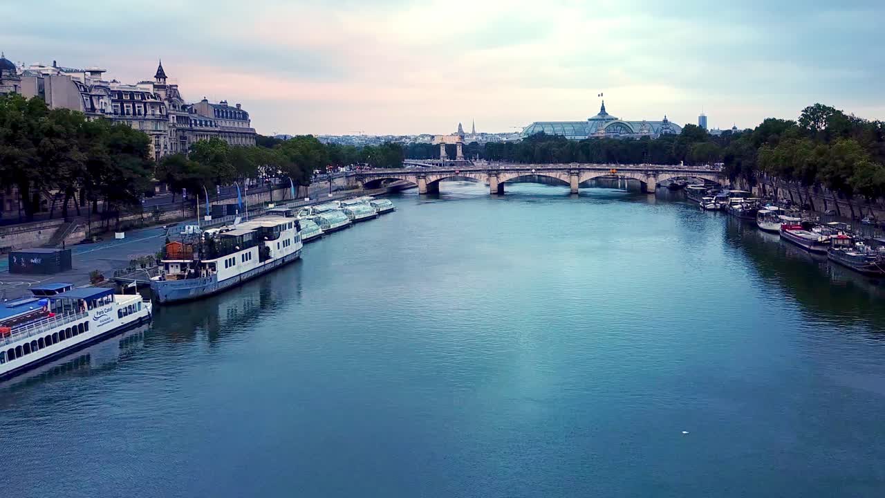 aerial moving forward going down, towards blue seine River and Grand Palais at snrise