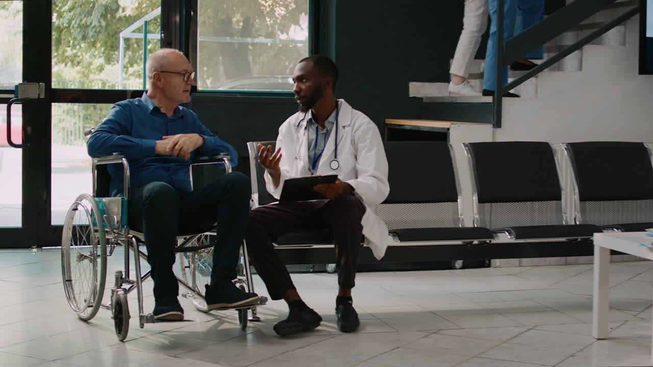 General practitioner talking to senior man in facility lobby