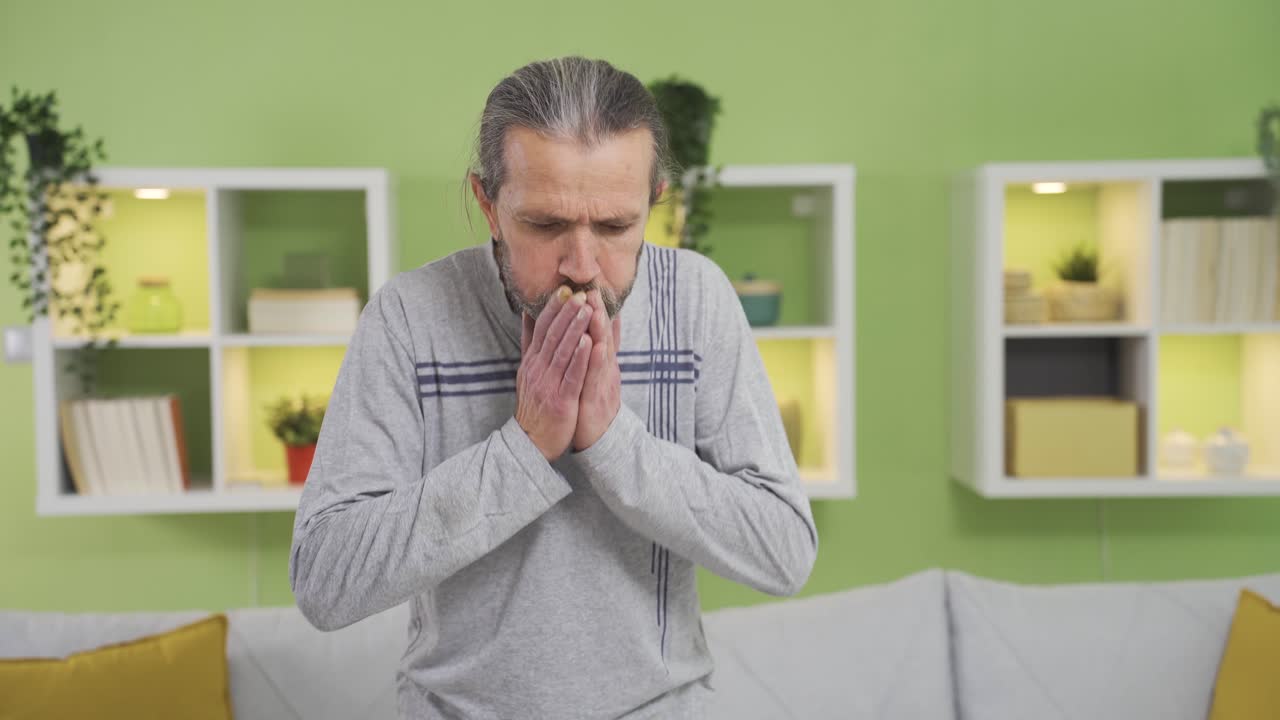 hombre con problemas de salud que tose en casa y se siente mal.