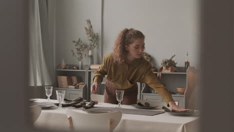 woman decorating plates with napkins