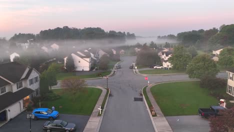 low fog covers american neighborhood during sunrise