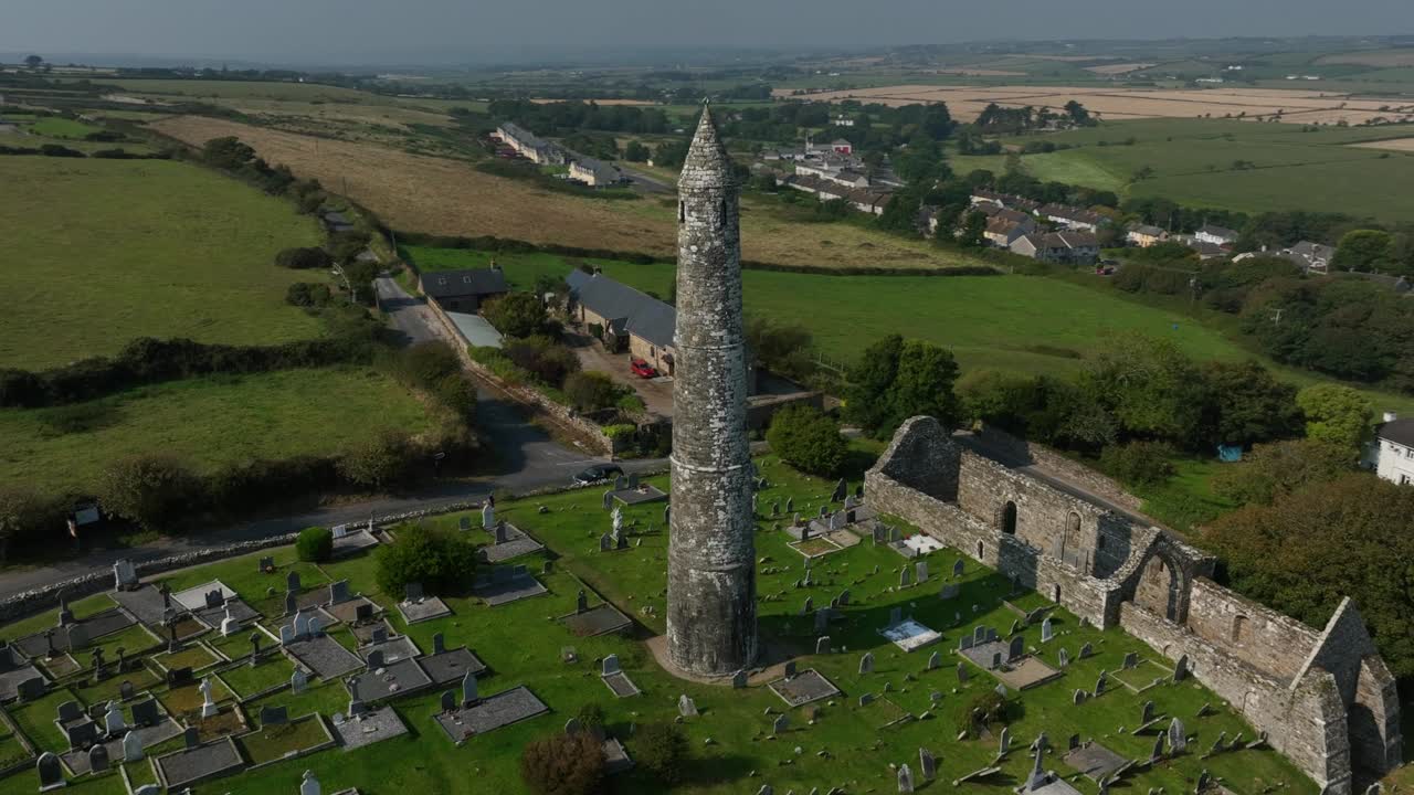 Aerial View of an Ancient Round Tower and Graveyard in Ireland