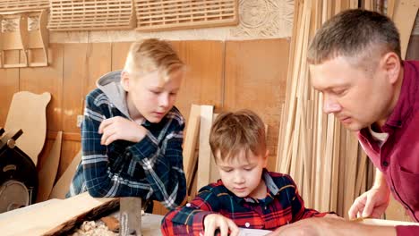 father and sons learning woodworking