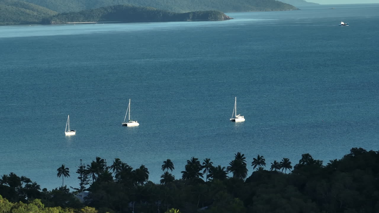 Drone shot of private yachts anchored up in the a bay in the Whitsunday Islands, QLD, Australia