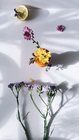 delicate cupcake arrangement with flowers and lemon