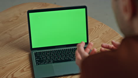 man video calling greenscreen laptop gesturing home closeup. businessman talking