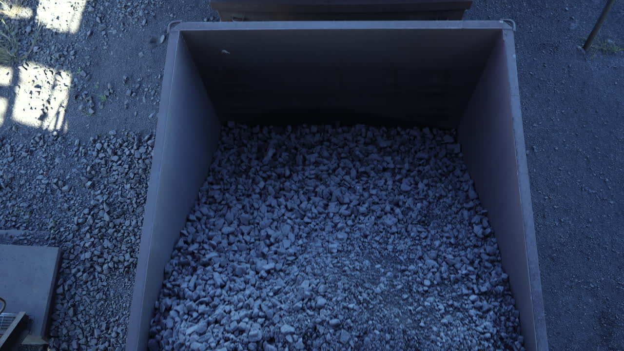 Overhead of mined ore in train wagons traveling on rail track