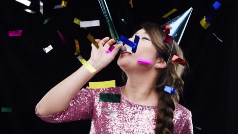 woman celebrating with confetti and party horn