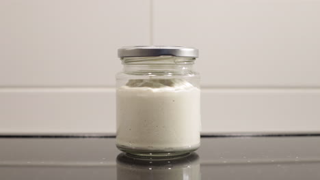 time lapse of a jar with beer yeast rising