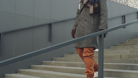 man walking up stairs in the city