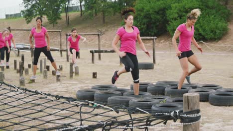 Female-friends-enjoying-exercising-at-boot-camp-together