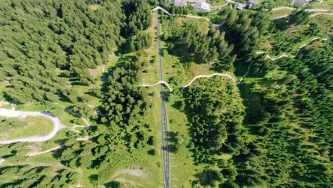4K-aerial-shot-of-cog-mountain-railway-tracks-and-gondola