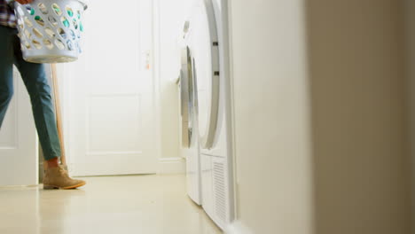 Front-view-of-black-man-holding-basket-of-clothes-at-comfortable-home-4k