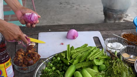 Skinning-red-onion-with-knife,-medium-shot