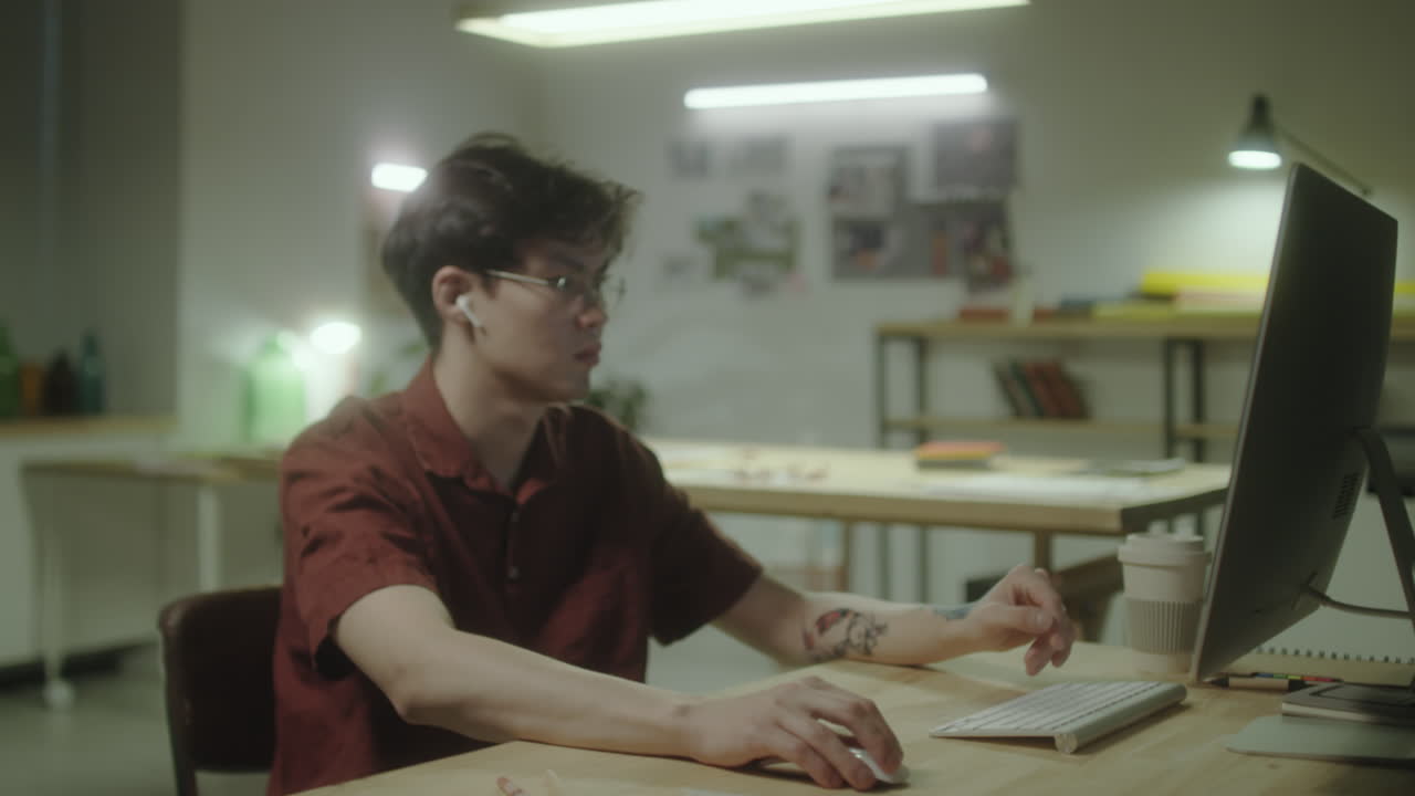 Young Man Working on Computer in an Office