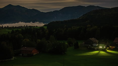 Evening-to-night-timelapse-of-the-Austrian-alps-scenic-remote-village-landscape,-Clouds-floating-over-European-village-with-mountains-in-the-background