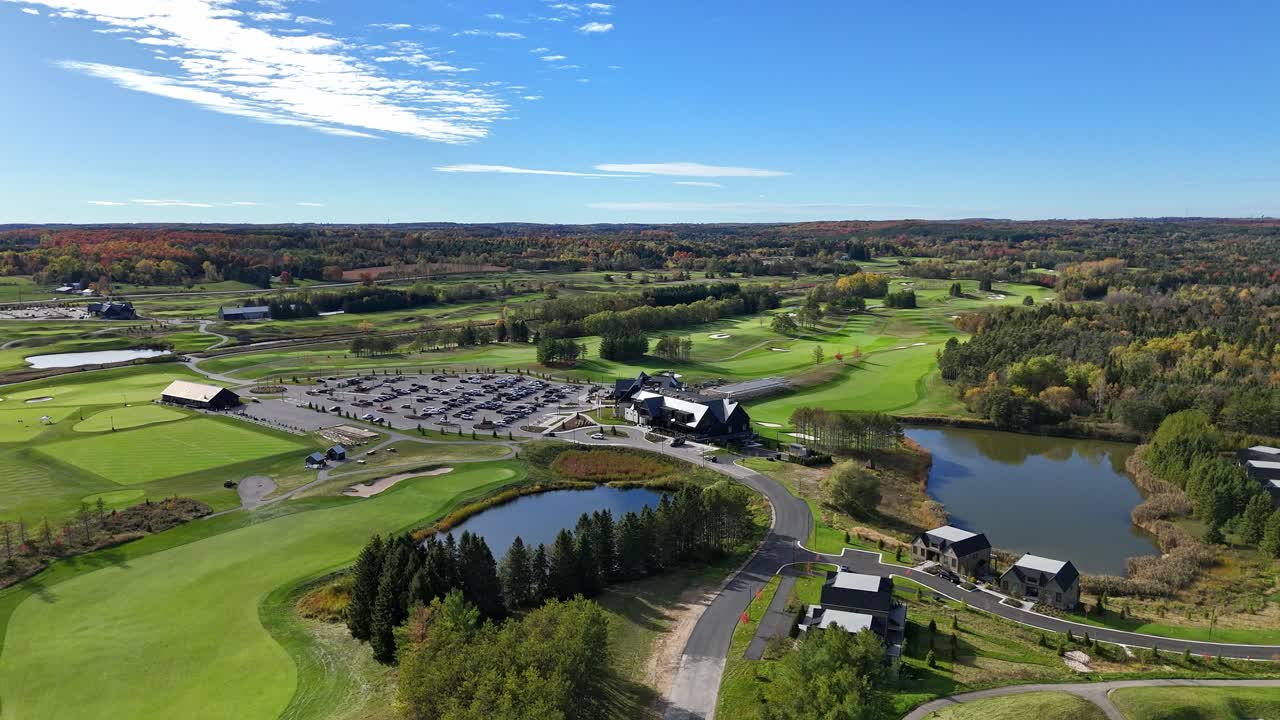 Sunny day aerial view of a golf resort surrounded by lush, mowed green lawns at TPC Toronto Osprey Valley Golf Course in Caledon, Ontario, Canada