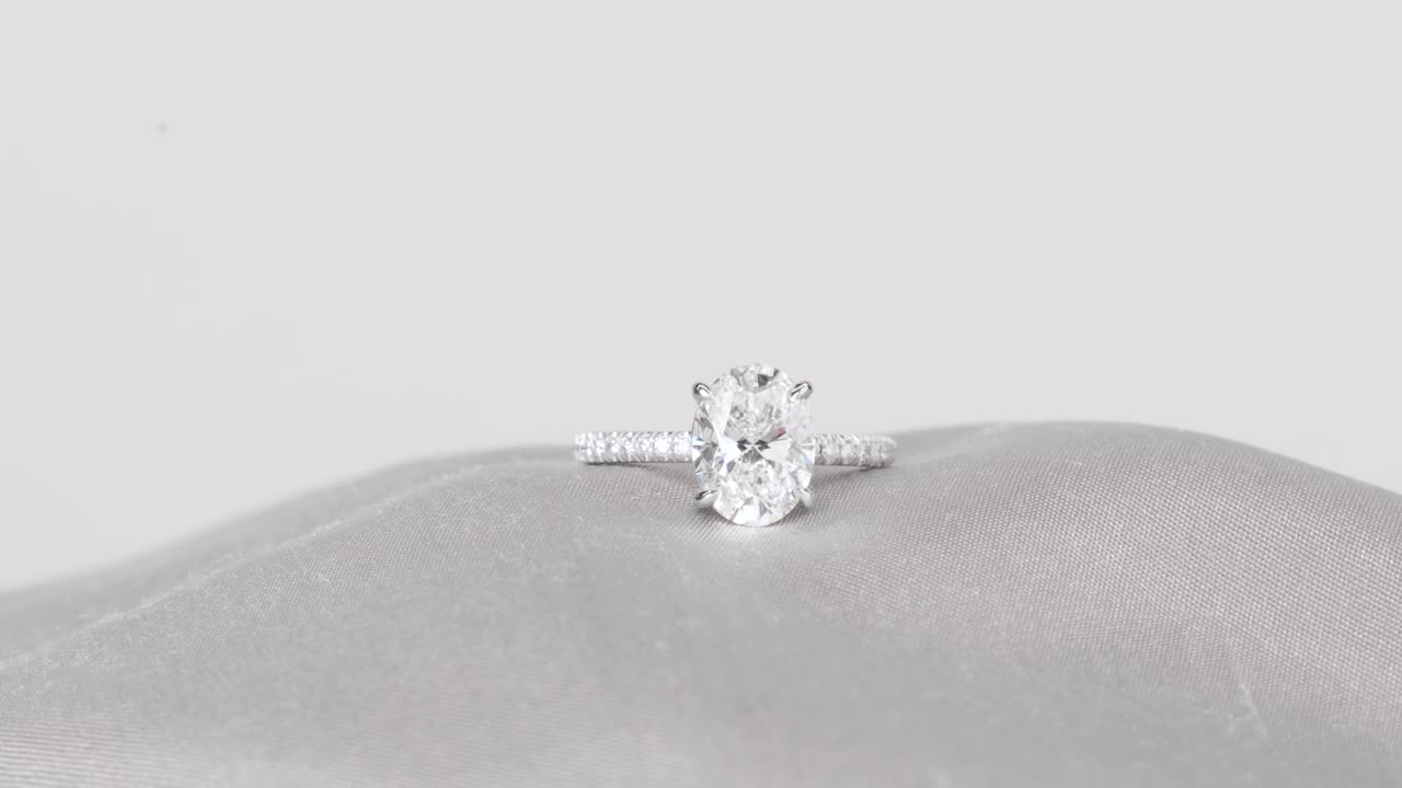 Sparkling diamond ring displayed on smooth satin fabric