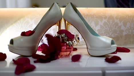 wedding shoe on the day of your preparation for the wedding with falling rose petals