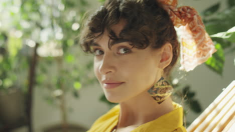 portrait of pretty woman among houseplants
