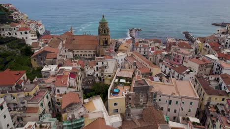 aerial over densely built coastal town and amalfi cathedral, salerno