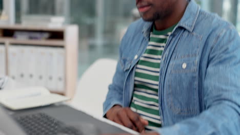 black man in office on laptop