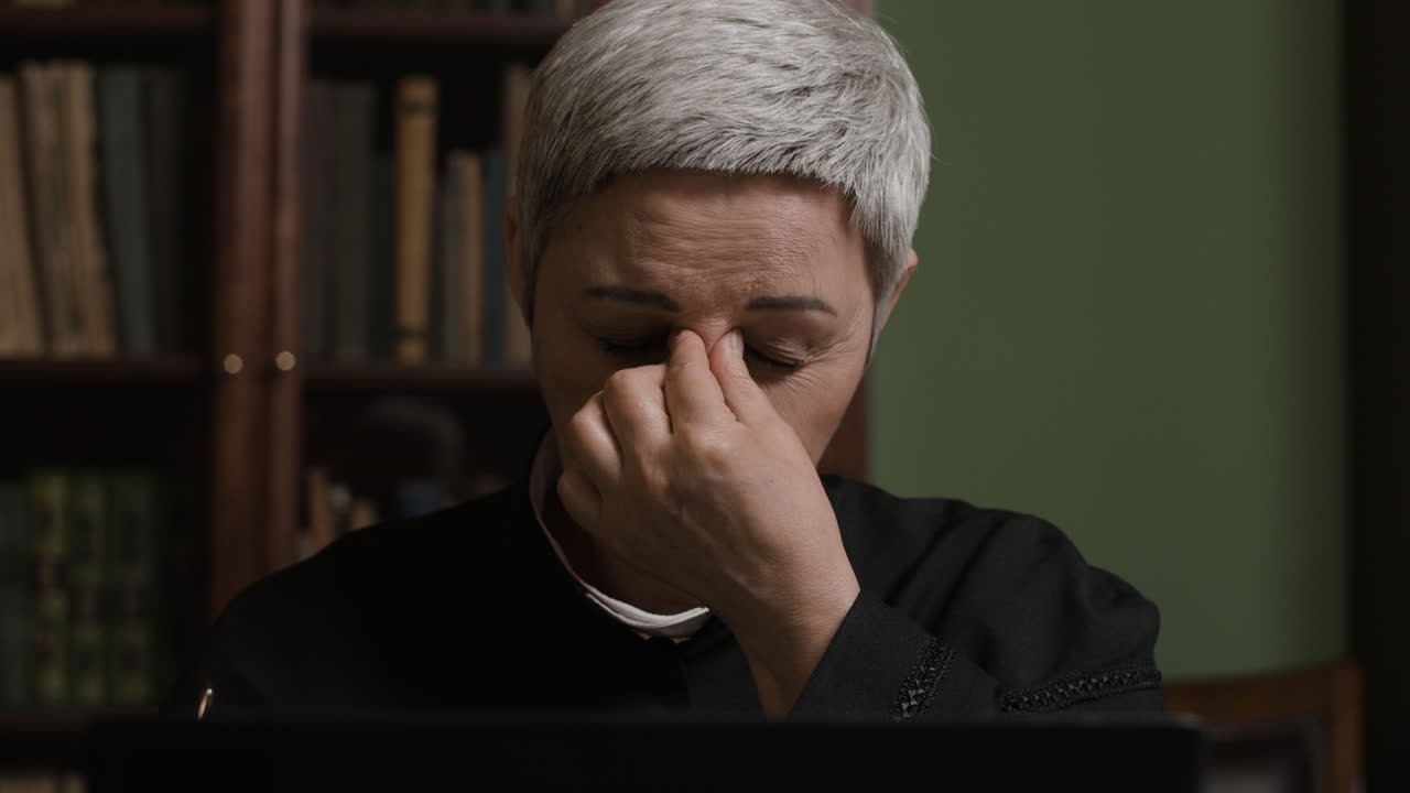 Stressed Clergywoman in Office