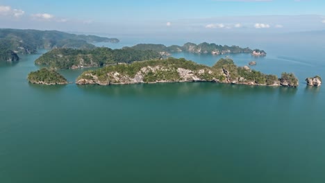 Aerial-flight-towards-Los-Haitises-National-Park-with-growing-mangrove-plants-on-rocky-islands---Samaná,-Dominican-Republic