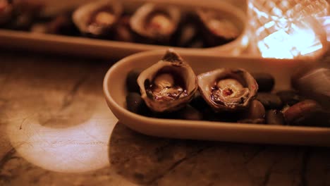 close-up of oysters on a dish with warm, ambient lighting. captured in gold coast, australia, highlighting culinary elegance and inviting atmosphere