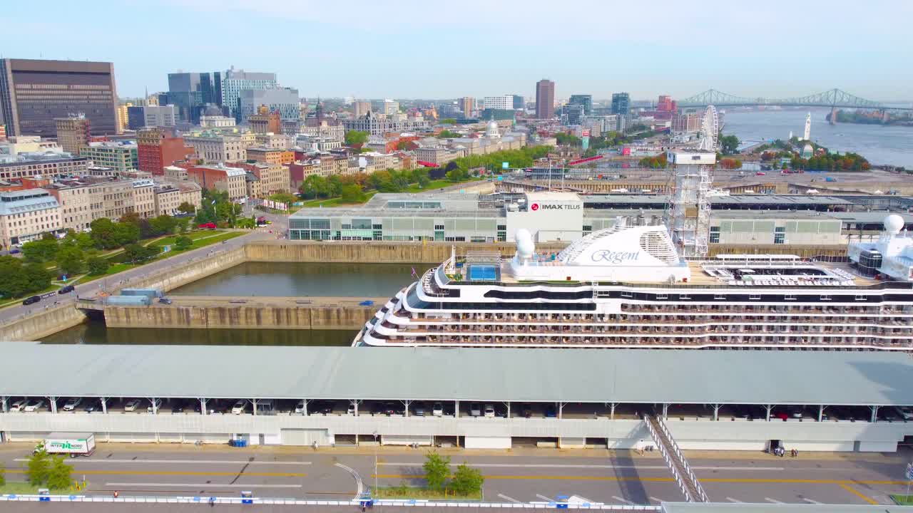 Docks and Regent cruiseliner with cityscape in the distance