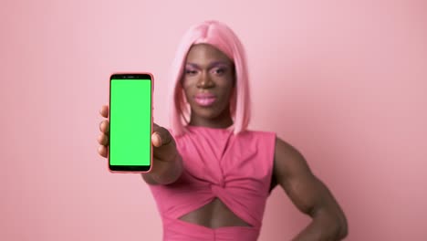 mobile held by a african transgender person on pink background
