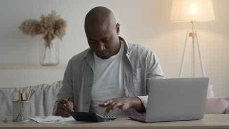 man working on finances at home