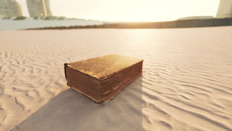 old book on the sand beach