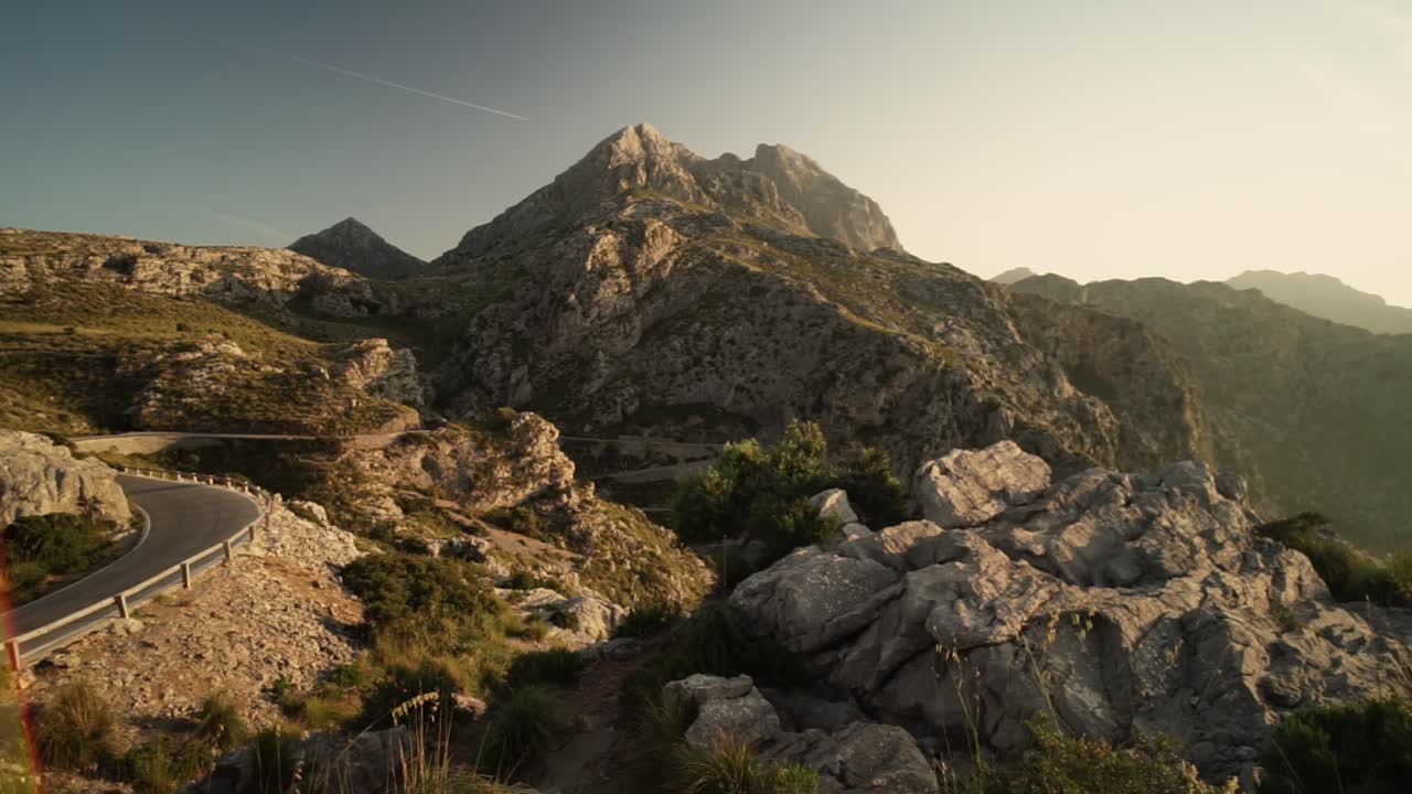 toma panorámica de caminos serpenteantes iluminados en nus de sa corbata, mallorca durante los rayos del sol al atardecer