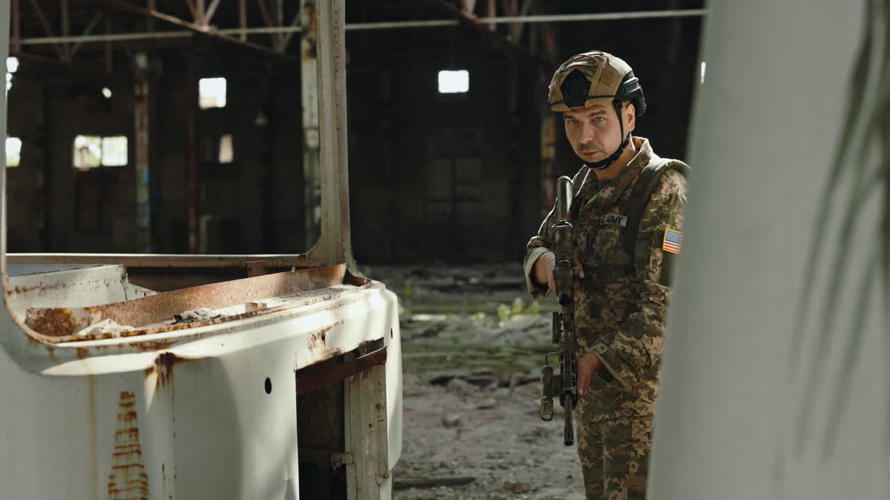 Soldier with rifle in abandoned factory