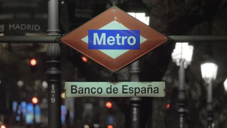 night view of banco de espana metro sign in madrid spain