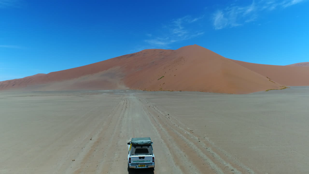 Aerial of AWD Jeep arriving at Dune 45 spot in Namibia, Sossusvlei.