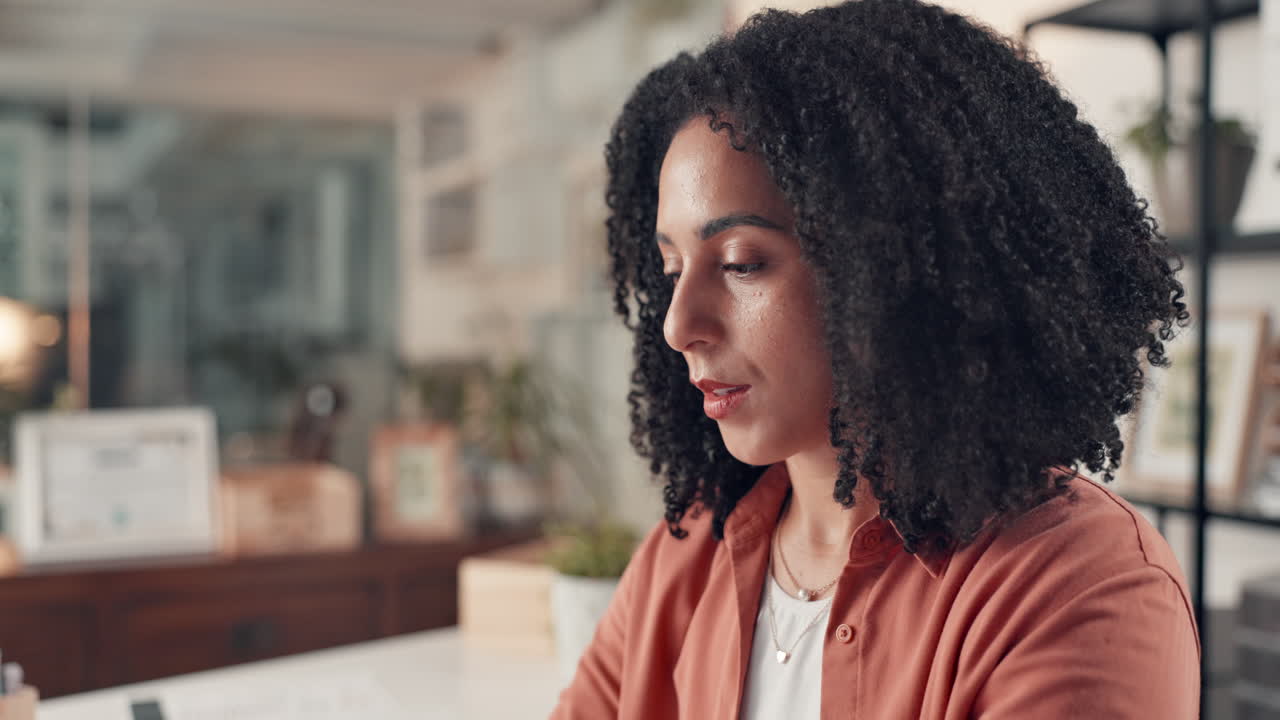 Portrait of a Thoughtful Businesswoman with Curly Hair in an Office